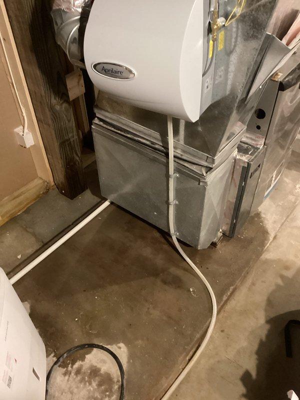 Responded to service call for reported furnace water leak. Upon arrival, inspected HVAC system and Aprilaire whole-home humidifier installation. Conducted thorough examination of humidifier unit, mounting, water supply lines, and drain connections. Verified all connections and components for signs of active leaking or moisture accumulation. Confirmed humidifier was functioning properly with no active leaks detected at time of inspection.