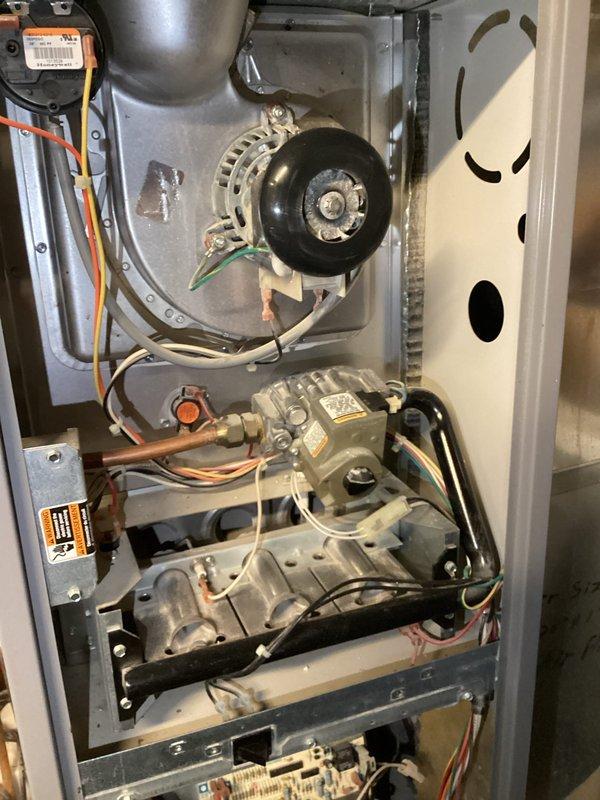 Responded to service call for furnace cleaning following construction activity. Upon arrival, performed comprehensive inspection and cleaning of gas furnace system. Removed access panels and assessed interior components for construction debris. Found light to moderate accumulation of sheetrock dust throughout unit. Thoroughly cleaned blower assembly, motor, heat exchanger, gas valve assembly, and inducer motor. Cleaned all interior surfaces and removed dust from electrical connections and wiring. Verified proper operation of all mechanical components. Reinstalled access panels and confirmed system functionality upon completion.