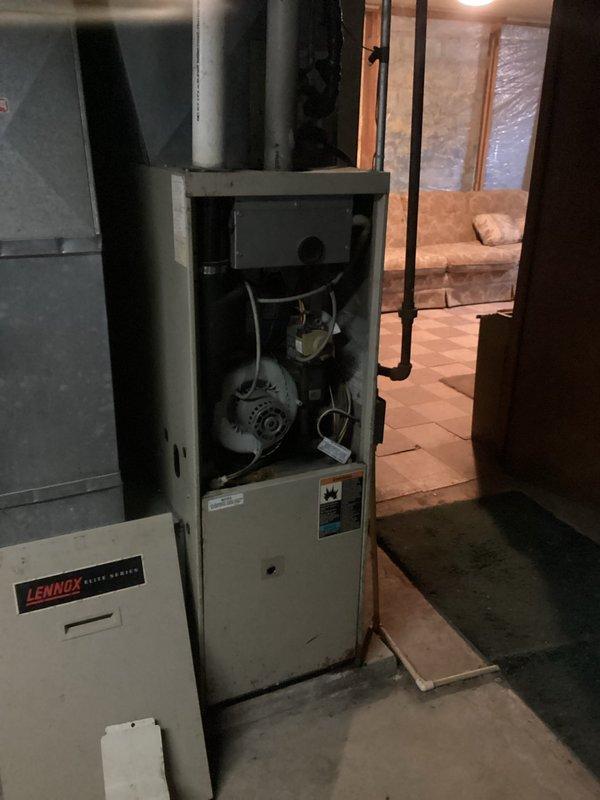 Responded to no heat call on residential furnace system that had been inoperative for several days. Upon arrival, performed diagnostic evaluation of the aging beige-cased furnace unit located in basement mechanical room. Opened access panel and inspected internal components including blower motor, fan assembly, and electrical system. Testing confirmed failed control board as root cause of system failure. Documented equipment condition through photography showing open furnace compartment with visible wiring and mechanical components, as well as adjacent Lennox unit in same utility space. Provided detailed repair estimate to address control board replacement and coordinated with project manager for scheduling of necessary repairs to restore heating functionality to the residence.