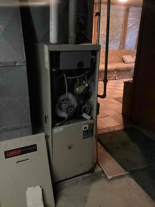 Responded to no heat call on residential furnace system that had been inoperative for several days. Upon arrival, performed diagnostic evaluation of the aging beige-cased furnace unit located in basement mechanical room. Opened access panel and inspected internal components including blower motor, fan assembly, and electrical system. Testing confirmed failed control board as root cause of system failure. Documented equipment condition through photography showing open furnace compartment with visible wiring and mechanical components, as well as adjacent Lennox unit in same utility space. Provided detailed repair estimate to address control board replacement and coordinated with project manager for scheduling of necessary repairs to restore heating functionality to the residence.