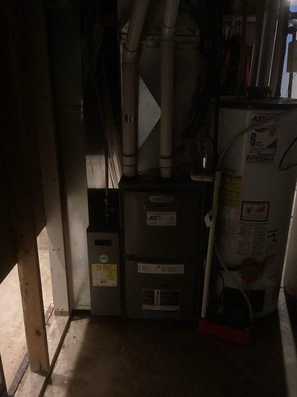 Responded to no heat call on residential furnace that had been inoperative for three weeks. Upon arrival, performed diagnostic assessment and identified failed inducer motor as root cause of heating system failure. Removed access panel to access internal components, disconnected electrical connections and pressure switch tubing from failed inducer assembly. Extracted defective inducer motor from furnace cabinet and installed new replacement inducer unit. Reconnected all electrical wiring, pressure switch hoses, and exhaust piping to new motor assembly. Tested system operation to verify proper inducer function, pressure switch activation, and ignition sequence. Confirmed furnace now heating properly and restored comfort to residence.