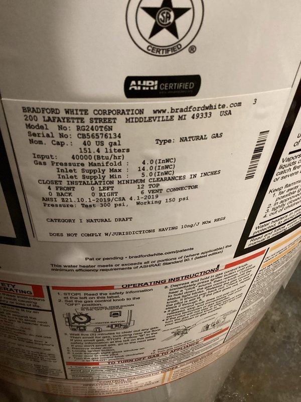 Responded to service call for leaking water heater in basement utility area. Drained and disconnected existing failed unit. Installed new Bradford White 40-gallon atmospheric vent water heater, model RG240T6N, with 40,000 BTU/hr natural gas input. Made all plumbing connections using existing copper supply lines and black gas piping. Connected natural draft venting system. Filled tank, purged air from lines, and lit pilot light. Tested gas valve operation and burner ignition. Verified proper venting and absence of leaks at all connections. Unit operating within manufacturer specifications upon completion.