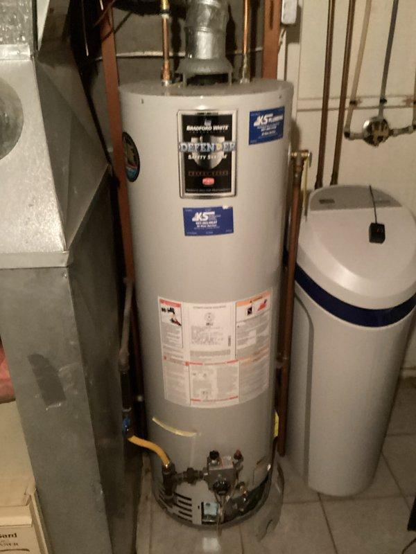 Responded to service call for leaking tanked water heater in basement utility room. Upon inspection, confirmed active leak originating from bottom of tank, indicating internal tank failure. Documented existing installation including copper supply lines, expansion tank, safety components, and proper venting configuration. Provided comprehensive estimate for complete water heater replacement with new unit, including removal and disposal of failed equipment, installation of new tanked water heater with code-compliant connections, and integration with existing plumbing infrastructure.