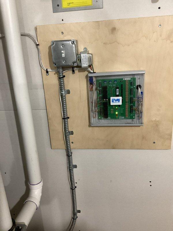 Completed comprehensive electrical inspection of residential property with focus on outlet concerns and overall system evaluation. Documented electrical panel with properly labeled circuit breakers and digital monitoring display, verified all connections secure with organized wiring entering through top conduit. Inspected auxiliary electrical installation including junction boxes, flexible metal conduit, and electronic control board housed in clear protective enclosure mounted on plywood backing. All components found to be properly installed and functioning within code specifications.
