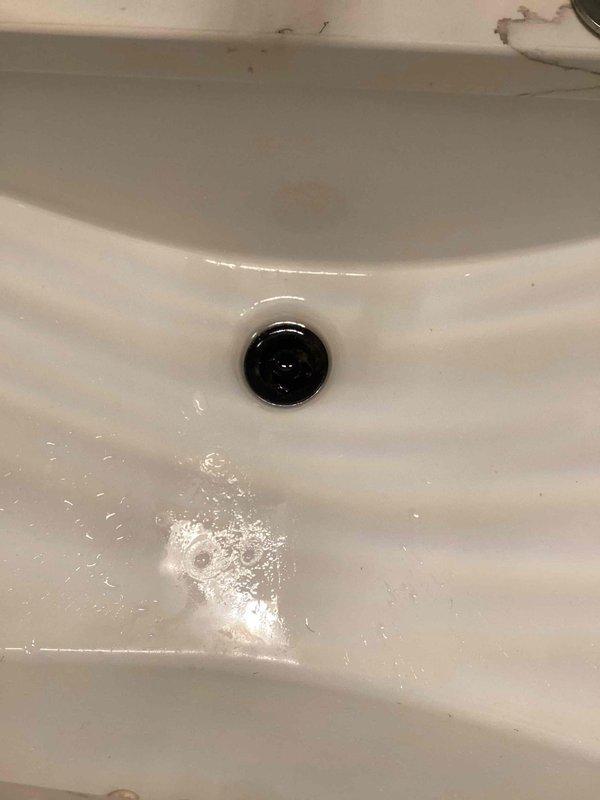 Responded to service call for multiple plumbing issues including clogged drains, dishwasher leak, and laundry room sink replacement. Successfully cleared drain line for main floor guest bathroom lavatory faucet, restoring proper drainage function. Provided detailed estimate for complete laundry room sink replacement including new basin, faucet assembly, and drain installation. Documented existing conditions of bathroom sink showing normal wear and utility sink displaying heavy use with accumulated debris. All drain clearing work completed and tested for proper flow.