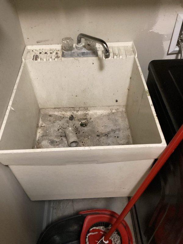 Responded to service call for multiple plumbing issues including clogged drains, dishwasher leak, and laundry room sink replacement. Successfully cleared drain line for main floor guest bathroom lavatory faucet, restoring proper drainage function. Provided detailed estimate for complete laundry room sink replacement including new basin, faucet assembly, and drain installation. Documented existing conditions of bathroom sink showing normal wear and utility sink displaying heavy use with accumulated debris. All drain clearing work completed and tested for proper flow.