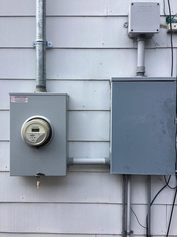 Responded to loss of power issue affecting garage door, hallway light, and multiple outlets that were tripping breaker. Upon investigation, diagnosed missing hot leg at electrical service entrance from meter. Coordinated with RPU to address utility-side power supply deficiency. Documented electrical meter and service panel configuration with photos showing exterior mounted components, conduit system, and service entrance equipment.