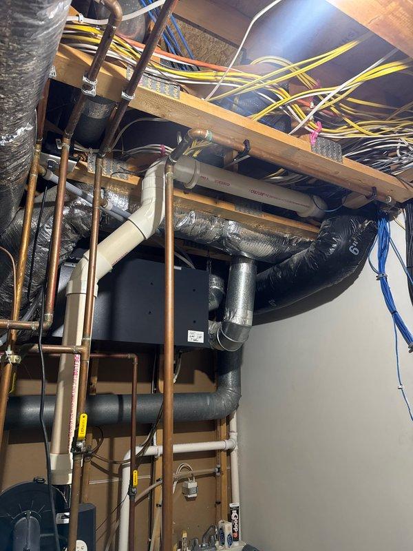 Responded to service call for clogged kitchen drain. Upon arrival, assessed the drainage issue and inspected the garbage disposal unit. Provided estimates for garbage disposal replacement, water heater replacement, and iron filtration system installation based on customer inquiry. Performed water quality testing which revealed elevated iron levels, documented existing plumbing infrastructure including copper supply lines, PVC drain lines, and mechanical systems in basement utility area.