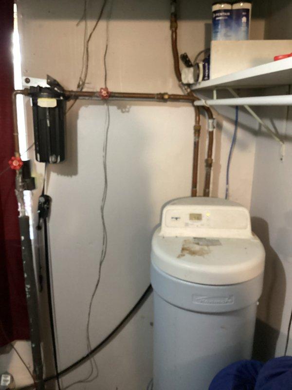Completed comprehensive plumbing inspection of main waterline, sediment filter, and water softener system. Identified three-quarter inch shut-off valve before meter with broken handle requiring replacement, sediment filter before water softener needing routine maintenance every six months to one year based on condition, and aging Kenmore Ultra Soft 180 water softener exceeding 15-year resin lifespan requiring replacement. Recommended replacing flexible water supply lines with traditional hard copper piping during softener replacement for improved durability and code compliance, and provided detailed estimate for all recommended repairs and upgrades.