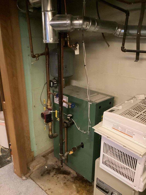 Responded to service call for noisy boiler and gurgling baseboard heaters. Upon inspection, determined system water level was critically low, causing air entrainment in hydronic distribution lines. Added water to boiler to restore proper system pressure and eliminate operational noise. Verified equipment returned to normal operation with quiet performance throughout baseboard heating zones.