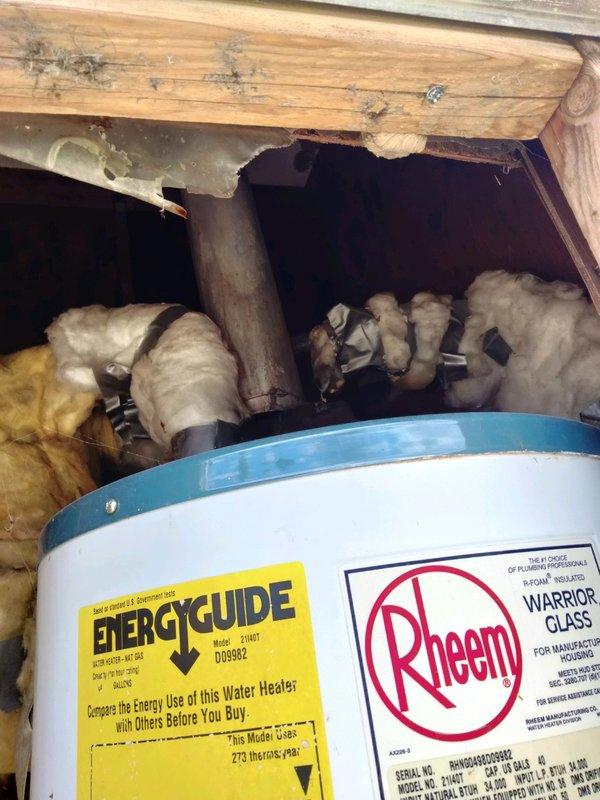 Responded to service call for water heater expelling steam and clogged kitchen sink. Upon arrival, inspected 30-year-old 40-gallon LP atmospheric vent water heater and found unit had sunk into severely rotted subfloor, causing vent pipe to detach from appliance. Red tagged water heater due to improper venting creating unsafe condition and potential carbon monoxide hazard. Assessed kitchen sink drain system and confirmed clog requiring clearing. Documented conditions with photographs showing compromised structural flooring beneath water heater, deteriorated wood framing, and sink drain configuration. Provided estimate for water heater replacement with new 40-gallon LP atmospheric vent unit including necessary subfloor repair, and separate estimate for kitchen sink drain clearing service.