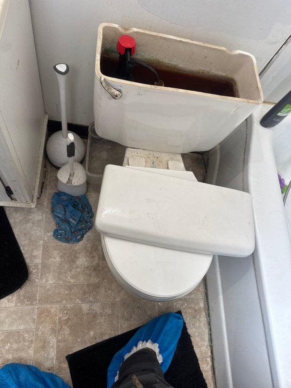 Responded to service call for toilet that was running constantly and experiencing double flushing issues. Upon arrival, inspected toilet tank and identified broken flush handle as primary cause of malfunction. Tank interior showed significant rust staining, mineral deposits, and corroded flush valve assembly, indicating age-related deterioration of internal components. Replaced defective flush handle with new unit to restore proper flushing operation and eliminate continuous running condition. Tested flush mechanism after installation to verify proper function and confirm resolution of reported issues.