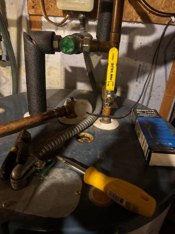 Responded to service call regarding odor emanating from hot water supply. Upon inspection of the 2019-installed gas water heater, confirmed the source of smell was a deteriorated anode rod. Replaced the sacrificial anode rod to eliminate sulfur bacteria buildup causing the unpleasant odor when hot water was used. Verified proper operation of pressure relief valve and inspected all plumbing connections at tank top. System tested and confirmed odor issue resolved following anode rod replacement.