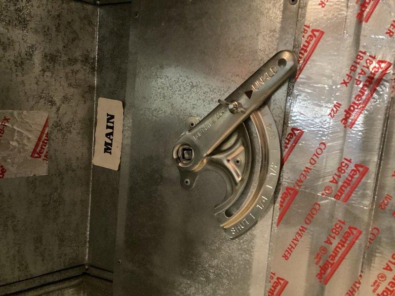 Responded to service call for dry bearing sound occurring at furnace startup. Upon inspection, identified damaged manual baffle in main floor duct causing swaying motion and squeaking noise during operation. Removed defective manual baffle from main floor ductwork to eliminate noise issue.