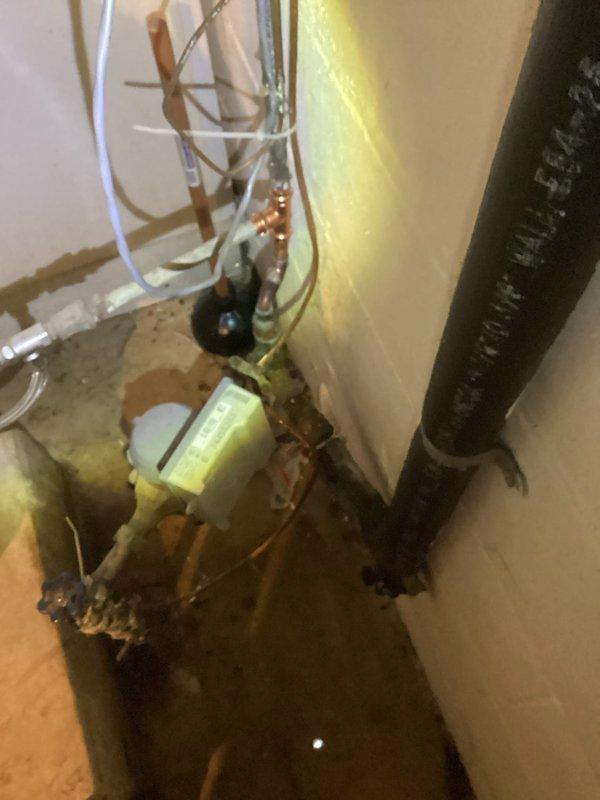 Responded to emergency call for burst pipe in basement. Upon arrival, located pinhole leak on 1/2" copper water main immediately after the meter. The leak was positioned near multiple existing fittings, requiring removal of compromised section. Cut out damaged copper pipe and old fittings, then installed new copper pipe with proper fittings to restore water main integrity. Tested system by restoring water service to the home and verified no additional leaks were present. All plumbing connections secured and water flow restored to normal operation.