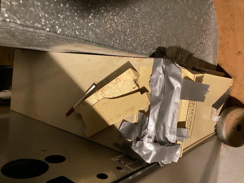 Responded to service call for air handler with broken filter cabinet door that was not sealing properly. Upon arrival, inspected the HVAC system and confirmed the filter housing was damaged and unable to maintain proper seal. Unit requires 20x25x5 filter media. Temporary repairs were attempted using metallic duct tape to secure the broken cabinet door and improve seal integrity. Documented existing conditions with photographs showing the damaged beige metal filter cabinet housing with tape application and visible structural compromise. Recommended replacement of the filter cabinet assembly to restore proper system operation and maintain air quality standards.