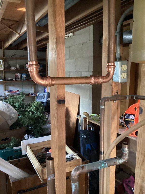 Responded to low water pressure issue affecting half of the residence. Upon investigation, identified malfunctioning water softener as the source of supply restriction. Bypassed the existing water softener system using copper piping to restore full water pressure throughout the home. Documented current plumbing configuration and provided estimate for complete water softener system replacement.
