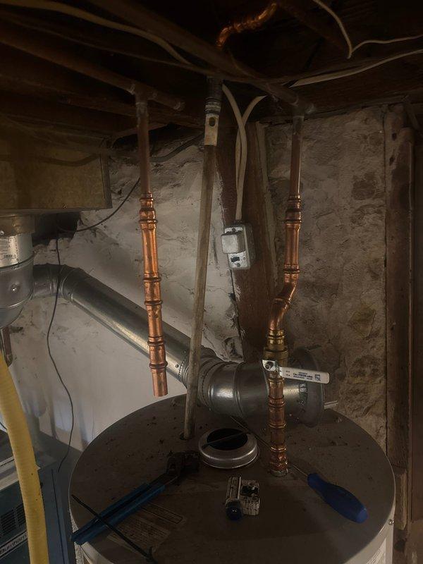Responded to customer complaint of rotten egg odor emanating from tanked water heater in basement. Upon inspection, identified severely deteriorated anode rod as source of sulfur smell, a common issue when magnesium or aluminum anode rods react with sulfate-reducing bacteria in the water supply. Removed and replaced worn anode rod with new unit to restore corrosion protection for tank interior. Performed system shock treatment by introducing bleach solution into water heater to eliminate bacteria causing odor. Flushed and sanitized entire system to ensure complete bacterial elimination and restore water quality.
