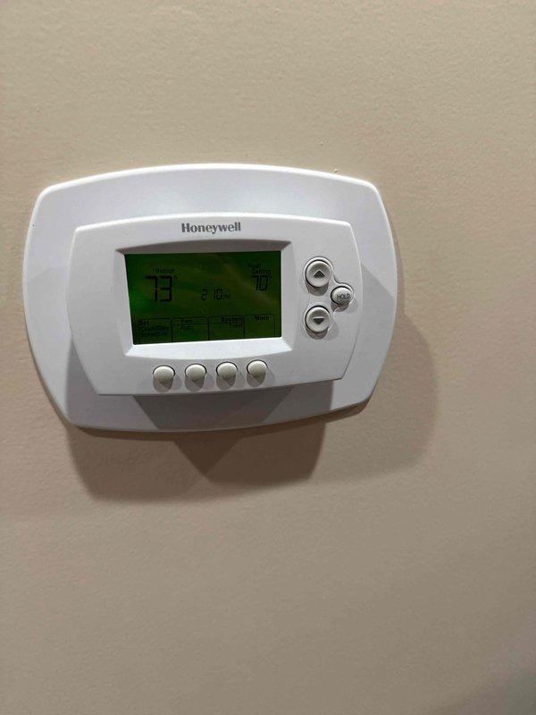 Responded to service call for heat pump system overheating home beyond thermostat setpoint with inconsistent furnace fan operation and continuous humidifier water flow. Upon arrival, diagnosed main floor zone damper failing to close completely, causing system to overheat living space particularly during nighttime hours. Inspected Honeywell programmable thermostat and reviewed scheduling settings with homeowner, who adjusted temperature programming to compensate for damper malfunction. Examined inverter-driven heat pump outdoor unit, verifying proper operation of variable-speed compressor controls and electronic components. Recommended zone damper replacement to resolve overheating issue and restore proper zone control functionality. Noted concerns may be related to recent installation work requiring follow-up.