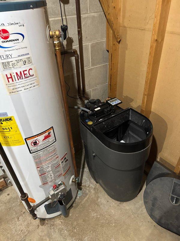 Responded to service call for water softener backwashing into utility sink with strong metallic odor. Upon inspection, determined the water softener system had failed and was discharging improperly. Recommended and scheduled unit replacement due to system failure beyond repair.