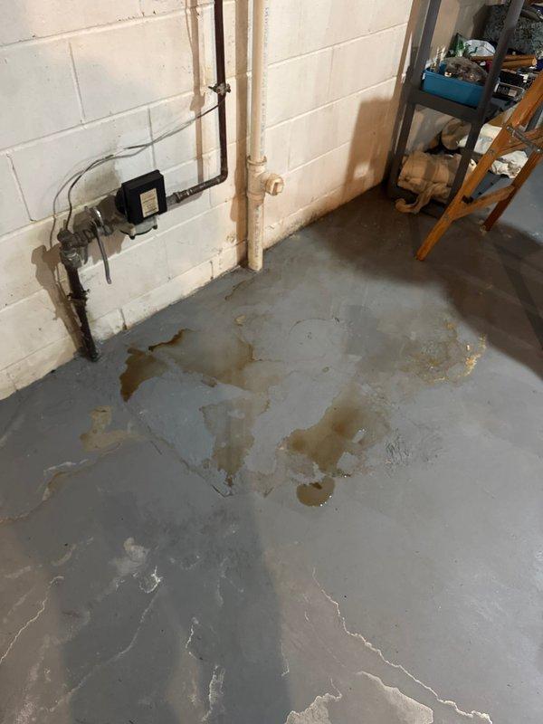 Responded to service call for multiple plumbing issues including a leak in the outdoor water line and a leaking garbage disposal requiring replacement. Upon arrival, discovered significant water damage in the basement area with visible staining and mineral deposits on the concrete floor, indicating active moisture intrusion from the compromised water line. Located and repaired the leak in the outdoor water line supply system, which had been causing water infiltration into the basement space. 

Proceeded to address the kitchen garbage disposal issue. Removed the failed disposal unit exhibiting active leaking and installed a new replacement unit, ensuring proper mounting, drain connections, and electrical hookup. Tested the new disposal for proper operation and verified all connections were secure with no leaks present. Confirmed water supply lines were functioning correctly and all plumbing connections were watertight throughout the affected areas.