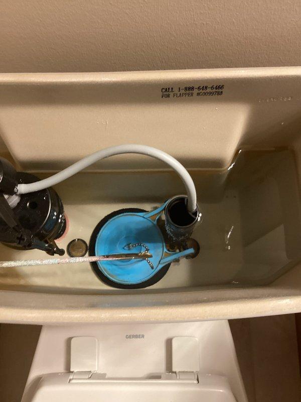 Responded to service call for master toilet that was running continuously and making periodic noise. Upon inspection, discovered the water supply tube had disconnected from the fill valve assembly and fallen into the flush valve housing, causing a siphoning effect that drained water from the tank and triggered constant refilling. Repositioned the supply tube back into its proper connection point on the fill valve, secured all components, and tested the toilet to verify proper operation and confirm the issue was fully resolved.