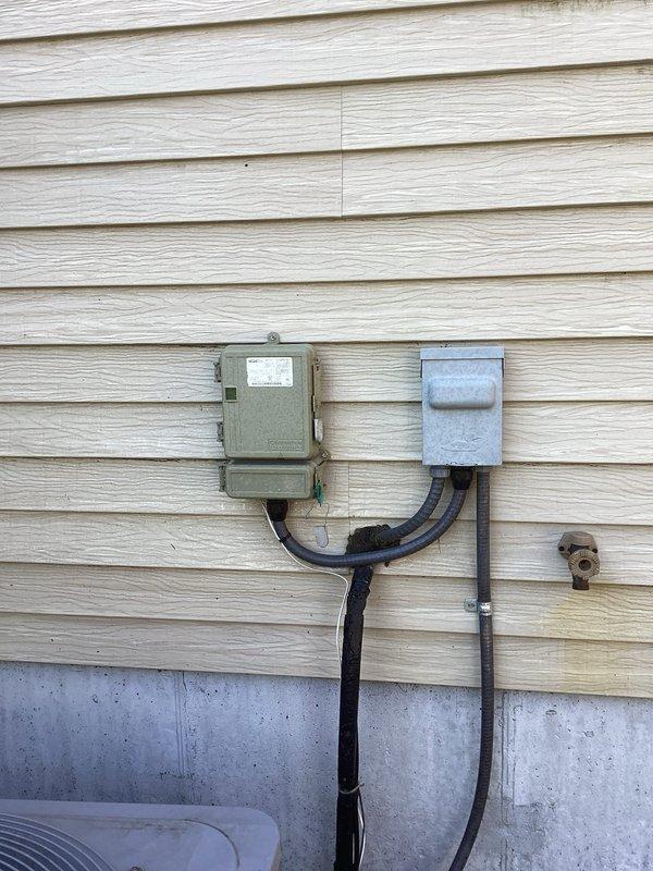 Responded to no cooling complaint on residential air conditioning system. Upon arrival, customer reported compressor not turning on and system completely dead. Performed diagnostic evaluation and found system operating normally at time of inspection. Identified energy saver device (load management box) installed on unit as likely cause of customer concern. Provided customer education on proper operation and function of energy saver box, explaining how utility company can temporarily cycle system off during peak demand periods. Confirmed system cooling capacity and normal operation. No repairs required.