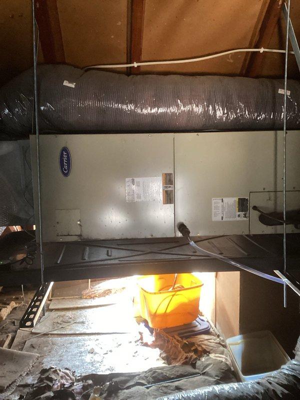 Responded to service call for attic-mounted Carrier air handler unit requiring drain pan installation. Upon arrival, accessed HVAC equipment in attic space and assessed existing air handler configuration. Successfully installed new drain pan beneath the unit to provide proper condensate collection and prevent potential water damage. Verified proper positioning and secure placement of pan under the air handler. Installation completed and system ready for operation.