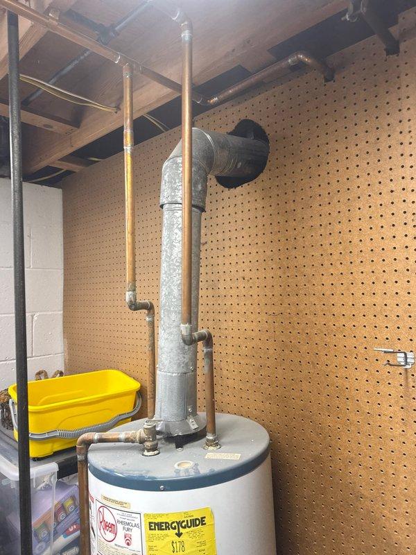 Arrived on-site to assess existing tanked water heater installation and provide estimate for replacement. Conducted thorough inspection of current unit, including evaluation of copper supply piping, metallic venting system, and connection points. Documented existing equipment specifications and installation conditions through photographic documentation for estimate preparation purposes.