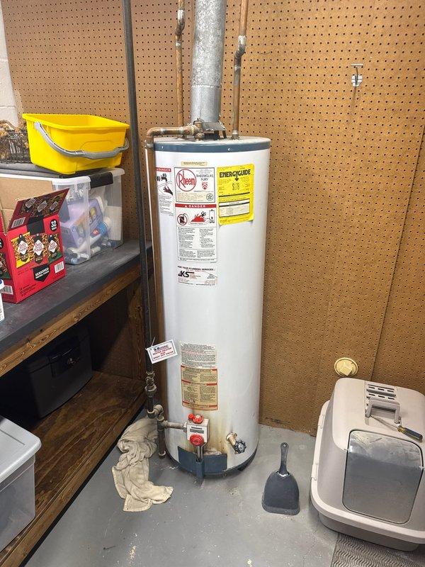 Arrived on-site to assess existing tanked water heater installation and provide estimate for replacement. Conducted thorough inspection of current unit, including evaluation of copper supply piping, metallic venting system, and connection points. Documented existing equipment specifications and installation conditions through photographic documentation for estimate preparation purposes.