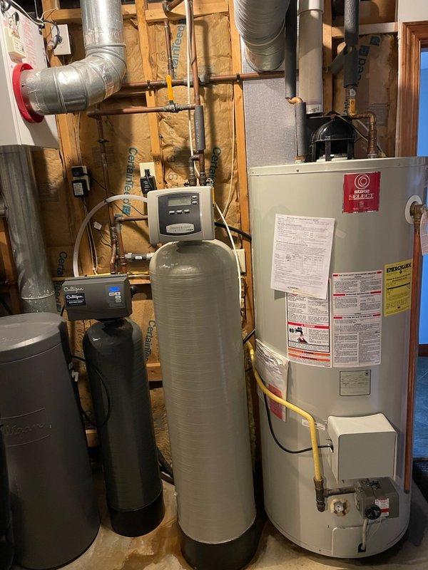Responded to service call for leaking water heater in residential utility area. Upon arrival, performed visual inspection and confirmed active water leak originating from the tank itself, with visible water accumulation on concrete floor beneath unit. Determined tank failure was beyond repair and recommended complete water heater replacement to prevent further water damage and restore hot water service to the property.