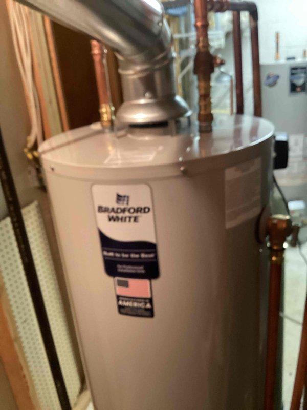 Removed existing water heater from utility area and installed new 40-gallon Bradford White tanked water heater per approved bid specifications. Connected all water supply lines, gas connections, and venting systems to manufacturer specifications, ensuring proper draft hood installation and code-compliant copper piping connections with appropriate shut-off valves.