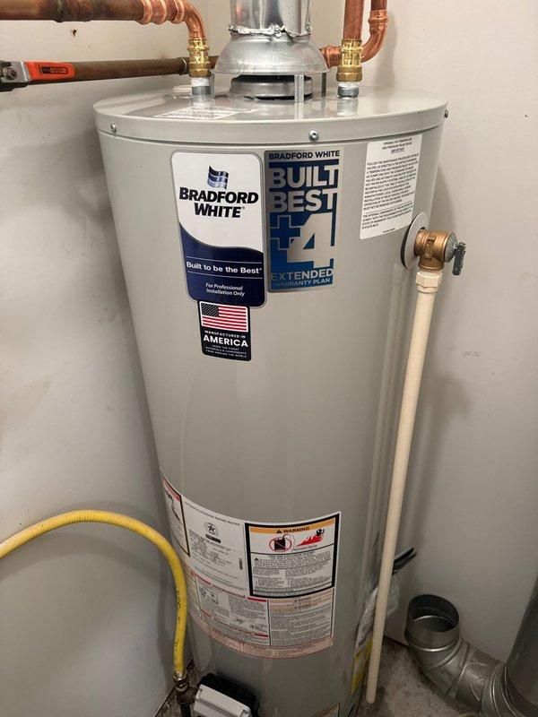Responded to service call for leaking water heater in residential utility closet. Upon arrival, confirmed existing water heater had developed active leak requiring immediate replacement. Removed and disposed of failed unit. Installed new 40-gallon Bradford White residential water heater per estimate specifications. Connected hot and cold water supply lines using copper piping with brass fittings and heat trap assembly. Attached galvanized metal vent pipe for proper exhaust ventilation. Connected yellow flexible gas line to unit and verified all gas connections for safety and code compliance. Installed temperature and pressure relief valve with PVC discharge pipe. Tested all connections for leaks, verified proper gas flow, and confirmed unit ignition and operation. System is fully functional with no leaks detected.