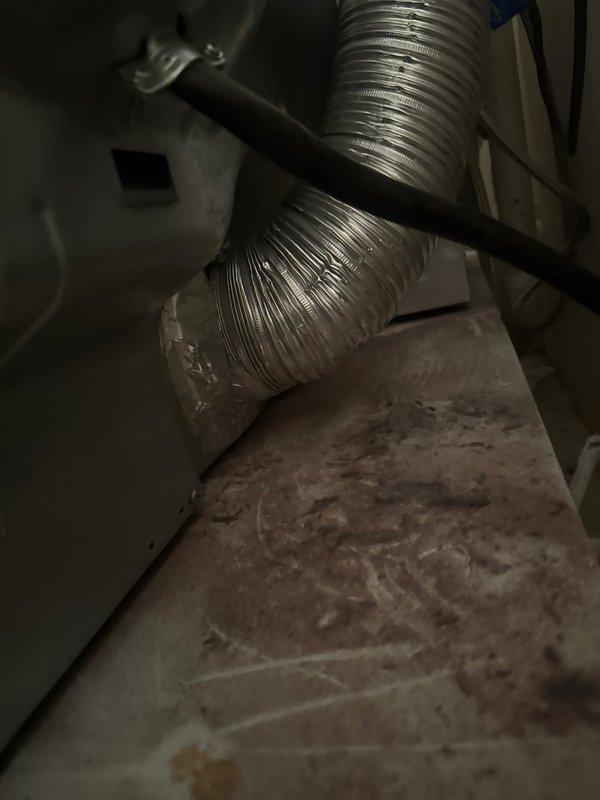 Responded to service call for disconnected dryer vent ductwork. Upon arrival, found that the flexible aluminum dryer vent had been previously disconnected, likely during a prior cleaning service. Reconnected the ductwork securely using a hose clamp and foil tape to ensure proper seal and prevent air leakage.