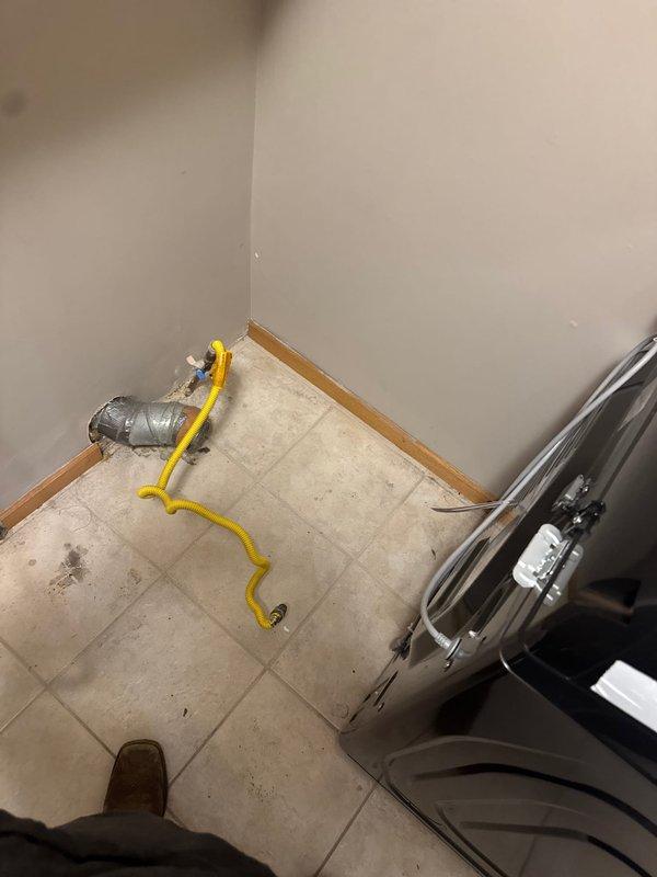 Completed gas dryer hookup installation using flexible gas line connector. Performed pressure test to verify system integrity and confirm no gas leaks at connection points, ensuring safe operation of the appliance.