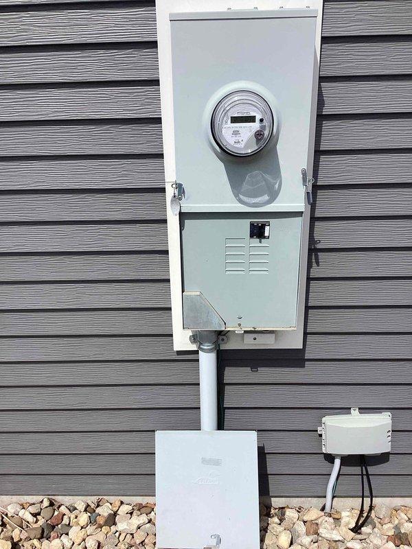 Performed on-site evaluation for electric vehicle charger installation in residential garage. Assessed existing electrical service and meter configuration to provide estimate for dedicated EV charging circuit with separate utility meter to enable off-peak charging rates. Documented current electrical infrastructure including main meter installation and garage interior layout to determine optimal routing and equipment requirements for proposed installation.