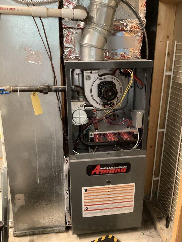 Responded to service call for Amana furnace reported to be continuously running and not shutting off when reaching set temperature. Upon arrival, performed diagnostic inspection of furnace operation, thermostat communication, and control board functionality. Removed access panel and inspected internal components including blower motor, electrical connections, and control systems. Attempted to recreate the reported issue through multiple heating cycles but was unable to duplicate the malfunction during service visit. All components appeared to be functioning within normal parameters at time of inspection. Advised homeowner that if the continuous running issue persists, thermostat replacement should be considered as the likely source of the problem, as intermittent thermostat communication failures can cause the symptoms described.