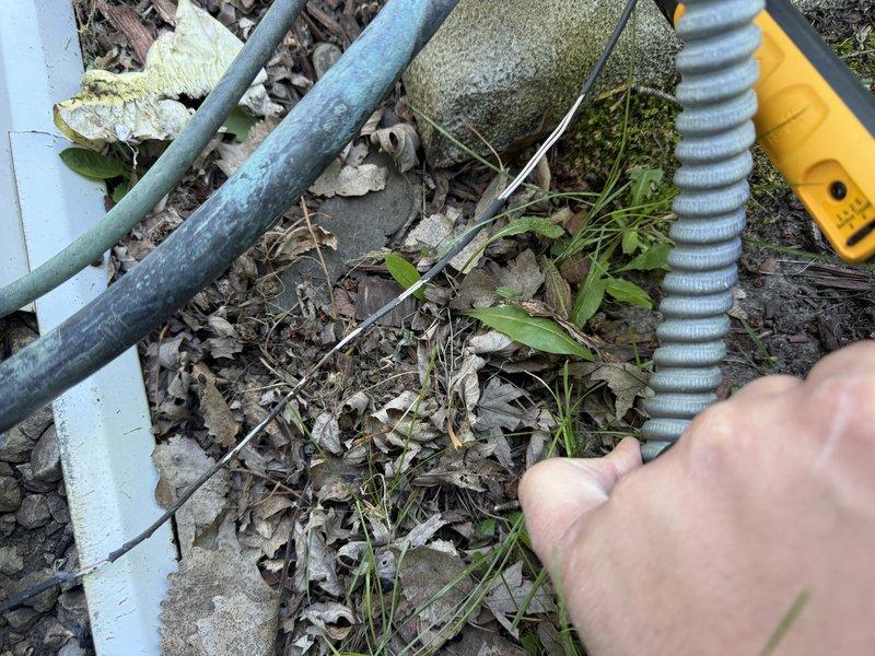 Responded to no cooling call on residential air conditioning system. Upon arrival, performed diagnostic inspection and identified multiple critical failures: contactor showed severe pitting and electrical degradation, wiring harness had broken connections compromising electrical integrity, and system was completely empty of refrigerant indicating a significant leak. Replaced failed contactor, repaired damaged wiring connections, and restored system to operational status with all necessary repairs completed.