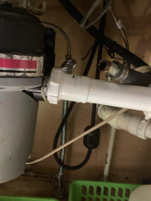Responded to water accumulation in mechanical room and kitchen drainage issues. Upon inspection, discovered the water softener drain line had disconnected from the floor drain cover, causing water discharge onto the floor during regeneration cycles. Additionally, identified a pinched dishwasher drain line and blockage in the drainage system preventing proper discharge. Reconnected the water softener drain line to the floor drain cover, cleared the blockage from the dishwasher drain line, and installed a new dishwasher drain connection fitting to the garbage disposal. Tested all systems to verify proper drainage and operation. All plumbing fixtures now functioning correctly with no further leakage.
