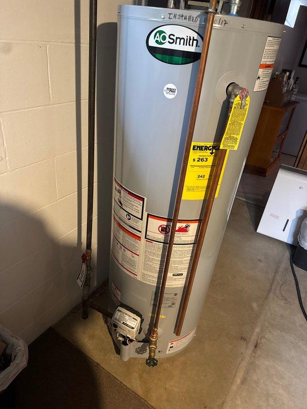 Responded to service call for non-operational gas water heater. Upon arrival, diagnosed gas valve failure indicated by error code on A.O. Smith tanked water heater unit. Determined gas valve was defective and beyond repair. Proceeded with complete water heater replacement due to component failure. Removed existing failed unit and installed new A.O. Smith residential gas water heater in basement utility area. Connected all necessary copper water supply lines with proper brass fittings, installed expansion tank, and established appropriate hot and cold water connections with shut-off valves. Verified all plumbing connections for proper seal and tested gas line connections for safety. Commissioned new unit, confirmed proper ignition sequence, and validated water heating functionality. System restored to full operational status.