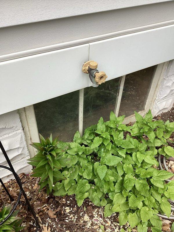Responded to a burst outdoor hose bibb that was leaking water into the basement of a century-old home with updated plumbing. Cut out and removed the failed hose bibb, installed a new brass exterior faucet on the foundation trim, and tested the system to confirm proper operation with no leaks.