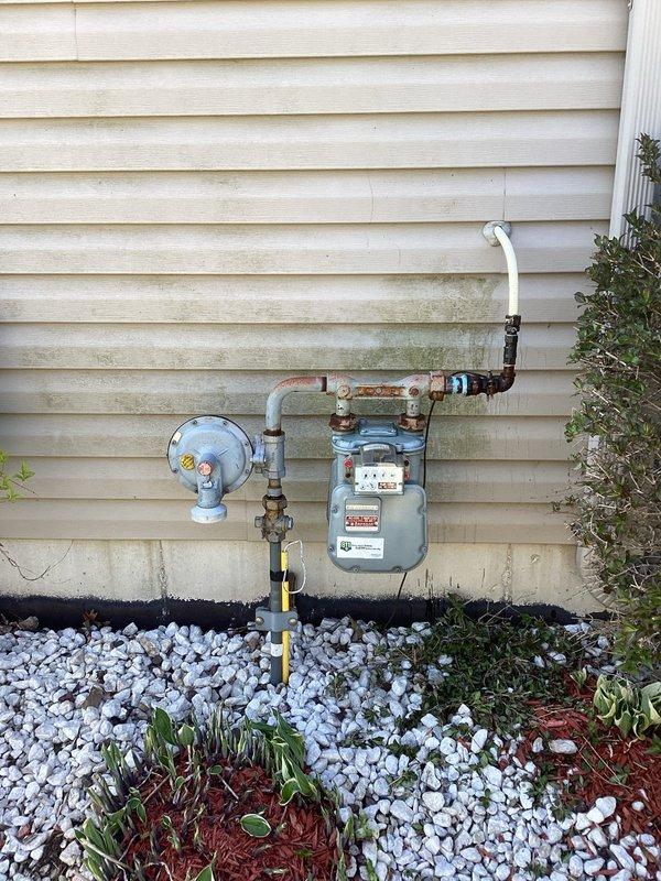 Responded to gas leak at main service line. Upon arrival, utility company had already marked the leak location at the gas meter assembly. Inspected the exterior gas meter installation and identified leak at the main gas line connection. Performed necessary repairs to eliminate the leak at the gas main. Verified system integrity and confirmed no further leaks present upon completion.