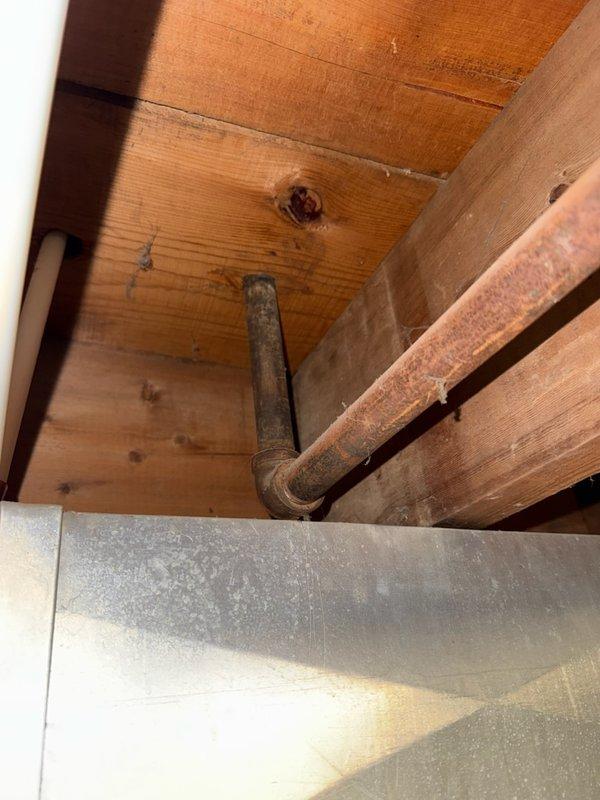 Removed an existing black iron gas line that extended through the floor behind the kitchen refrigerator. In the mechanical room, capped off the gas line by installing a 2-inch black iron nipple with cap to safely terminate the line and prevent any potential gas leakage.