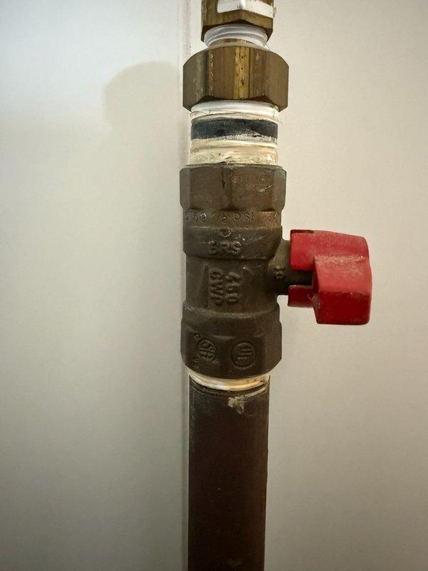 Removed an existing black iron gas line that extended through the floor behind the kitchen refrigerator. In the mechanical room, capped off the gas line by installing a 2-inch black iron nipple with cap to safely terminate the line and prevent any potential gas leakage.
