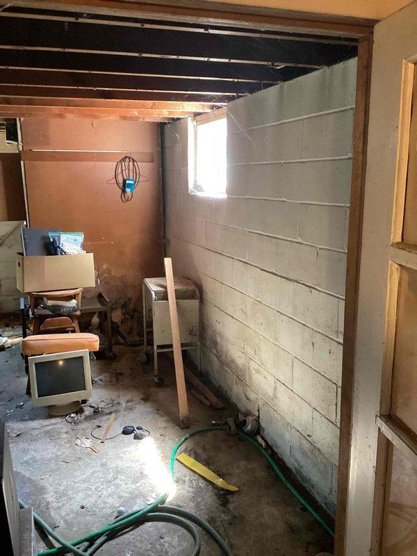Completed site assessment for new electrical outlet installation in unfinished basement utility area. Evaluated existing electrical panel configuration and circuit capacity to determine optimal connection point for additional outlet. Assessed workspace conditions including concrete block walls, exposed ceiling joists, and available routing paths for new wiring installation.