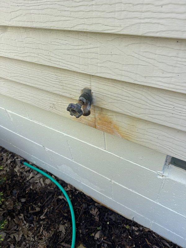 Replaced leaking outdoor hose bib on exterior wall due to active water leakage causing staining on siding. Inspected bathroom tub faucet and under-sink plumbing connections, confirming all supply lines and shut-off valves were functioning properly with no additional repairs needed.