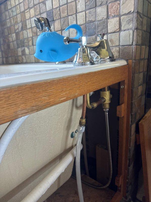 Replaced leaking outdoor hose bib on exterior wall due to active water leakage causing staining on siding. Inspected bathroom tub faucet and under-sink plumbing connections, confirming all supply lines and shut-off valves were functioning properly with no additional repairs needed.