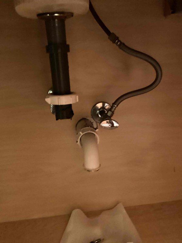 Responded to a clogged master bathroom lavatory drain caused by a spring-loaded pop-up assembly component that had become dislodged and fallen into the drain line. Disassembled the drain trap and tailpiece to access and remove the obstructing piece, cleared the blockage, and reassembled the drain system to restore proper drainage function.