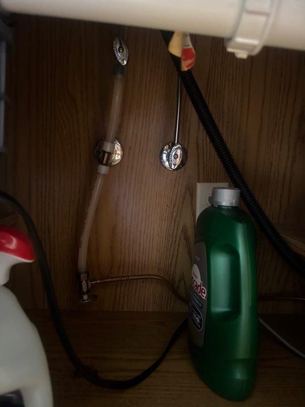 Completed faucet replacement at kitchen sink location. Removed existing faucet assembly, installed new pull-down style faucet fixture, and verified proper connection of hot and cold water supply lines to angle stop valves beneath sink. All connections tested and confirmed leak-free with full water pressure restored to both basins.