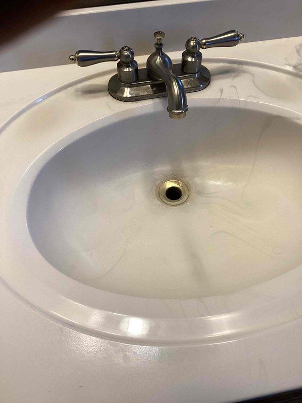 Responded to service call for corroded and leaking pop-up assembly on master bathroom lavatory faucet. Removed deteriorated pop-up drain assembly and installed new replacement unit. Tested faucet operation and verified all connections were leak-free upon completion.